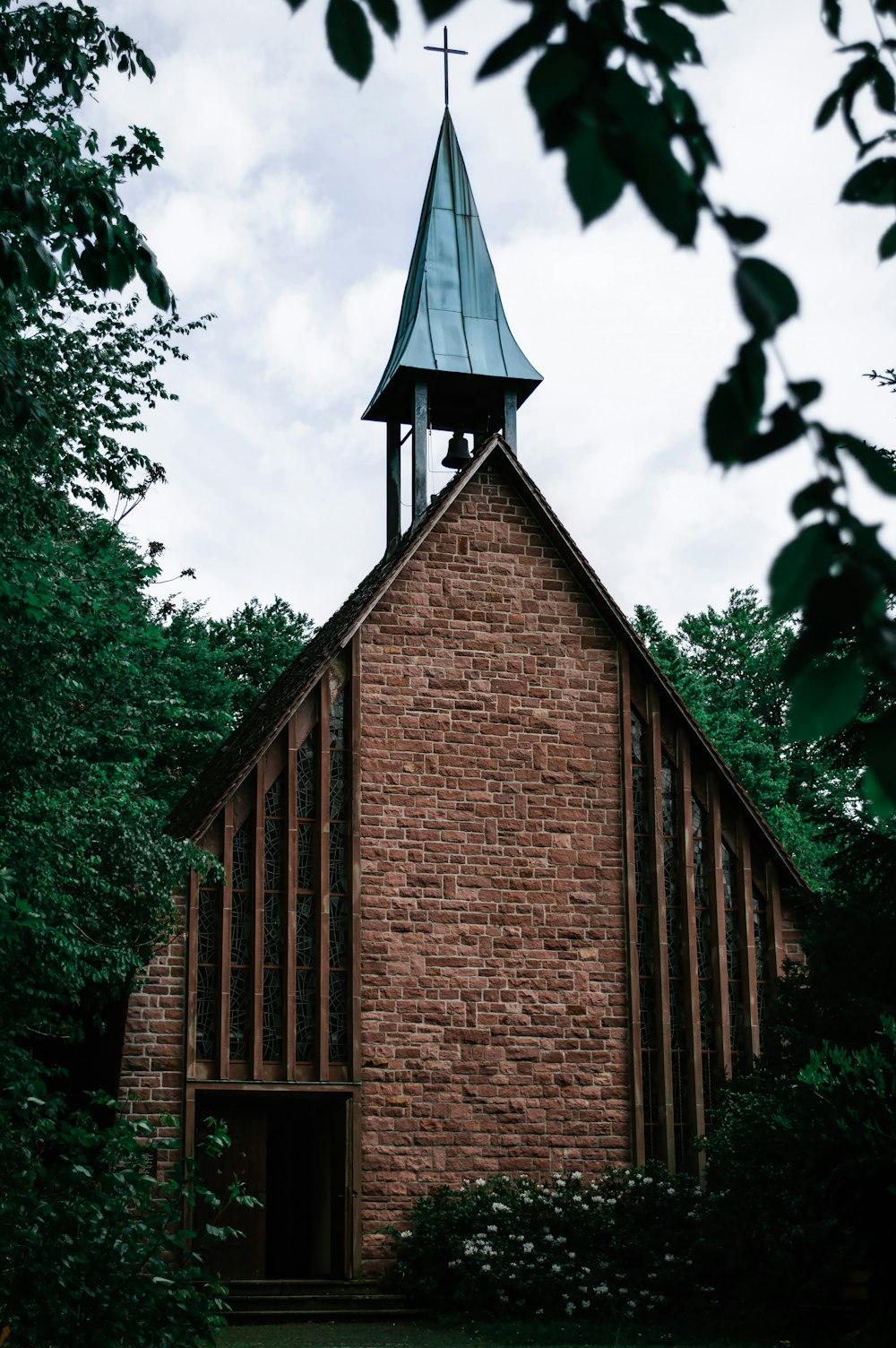 brown brick building near green trees during daytime