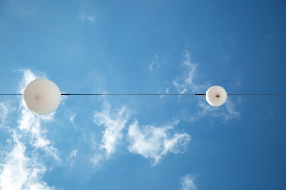 white light bulb under blue sky during daytime