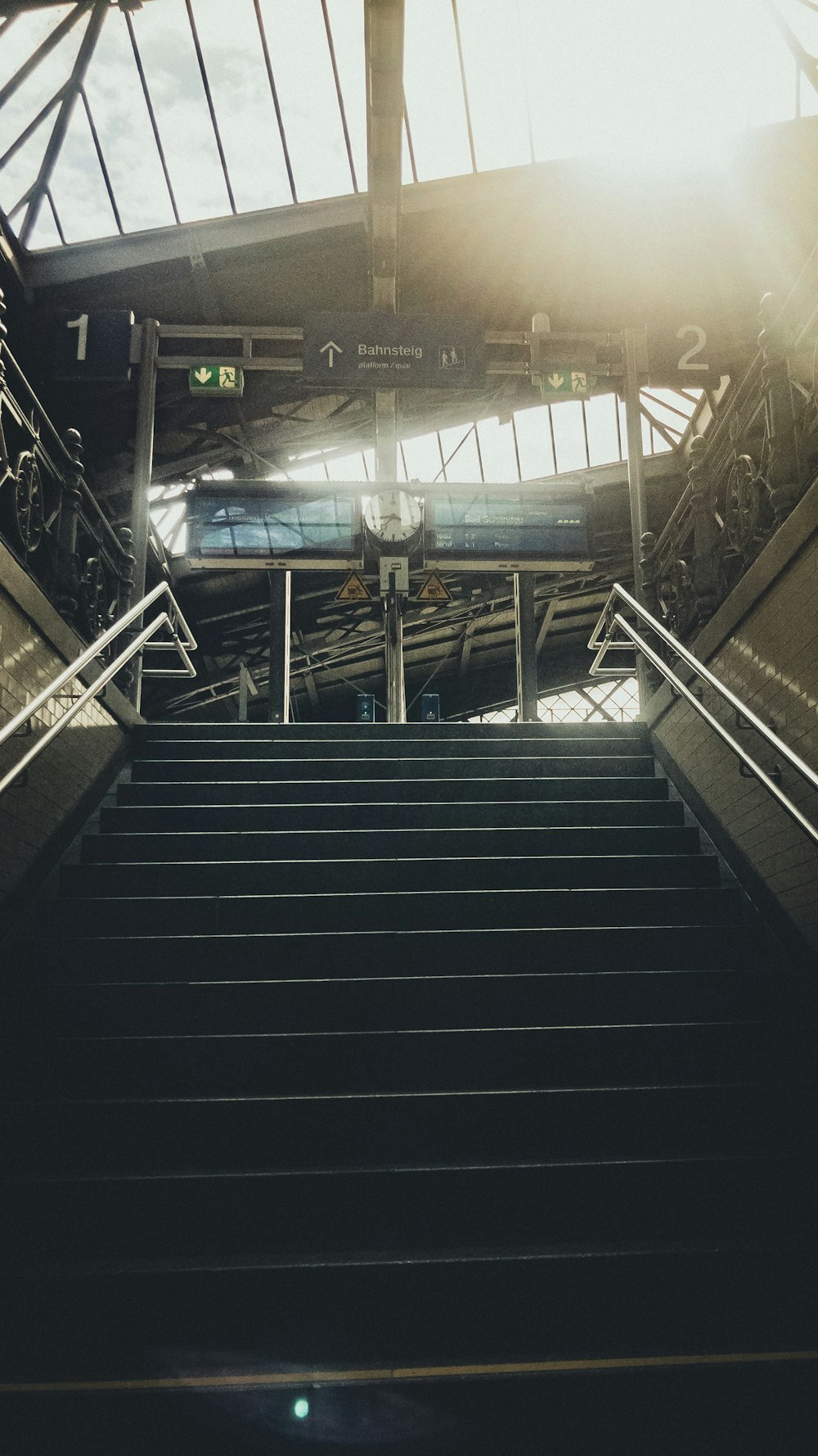 black and brown staircase with stainless steel railings