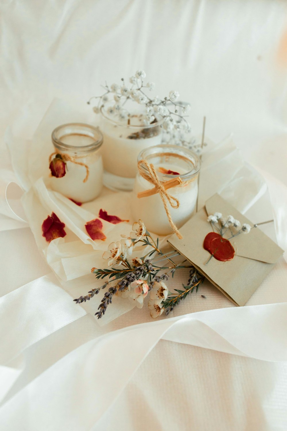 white ceramic mug with saucer on white textile