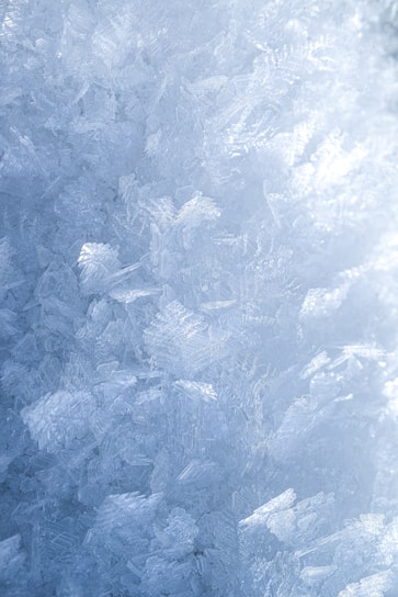 A close-up of delicate ice crystals glistening under soft morning light.