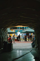 A high-performance sports stadium tunnel leading to a bright training ground, emphasizing elite environments.