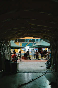 A high-performance sports stadium tunnel leading to a bright training ground, emphasizing elite environments.