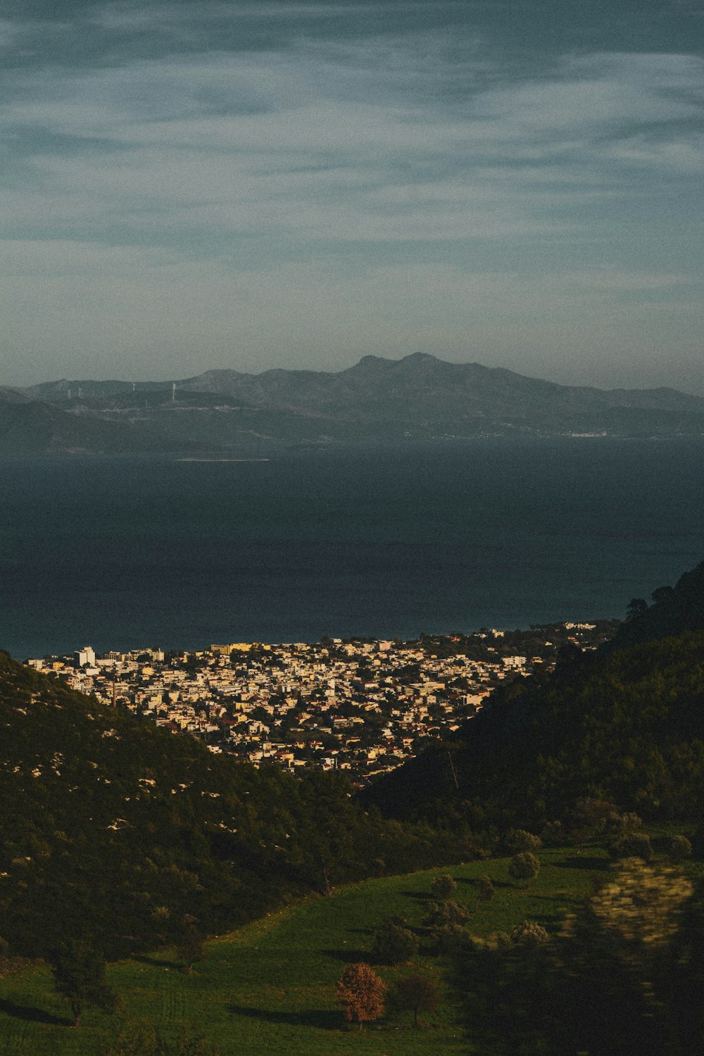 green mountains near body of water during daytime