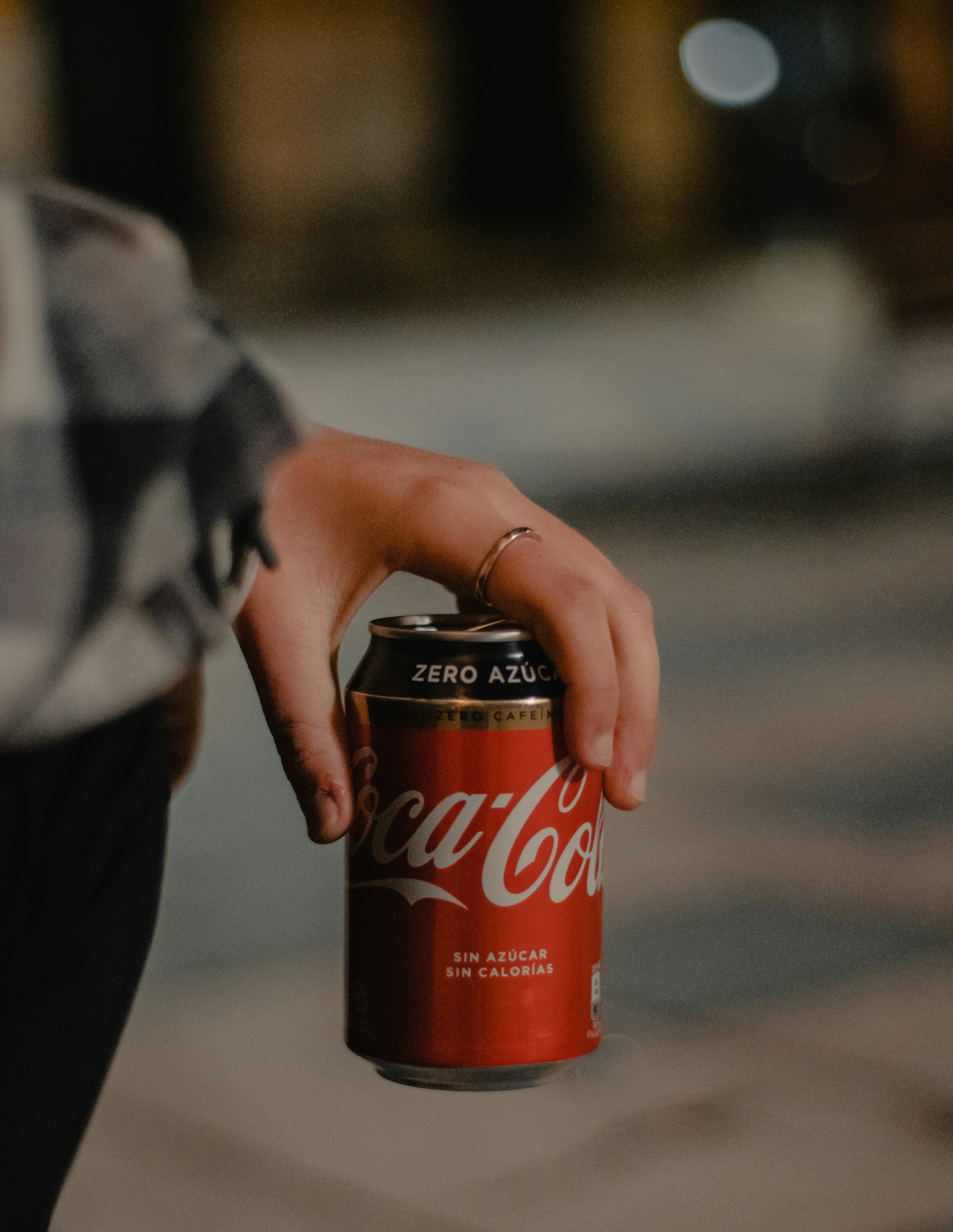 coca cola zero can on persons hand