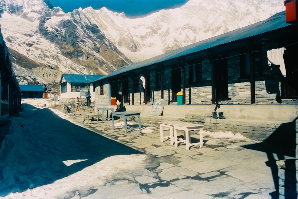 white and black building near snow covered mountain during daytime