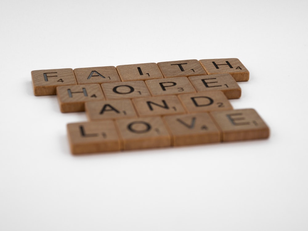 brown wooden puzzle blocks on white surface
