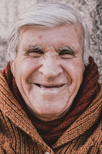 old man in red scarf smiling