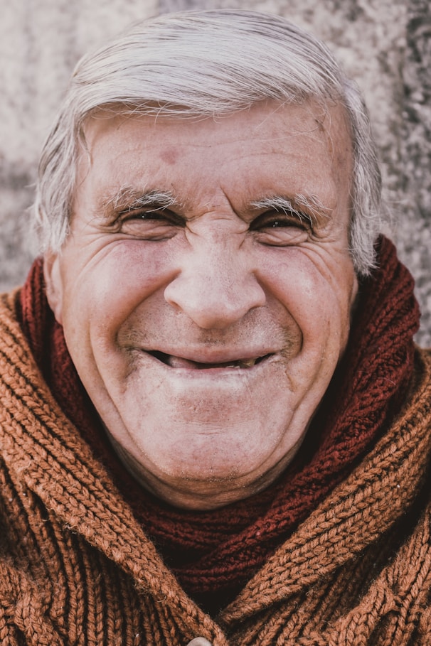 old man in red scarf smiling
