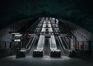 an escalator in a subway station at night