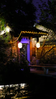 Evening view of svajonių namai’s welcoming entrance lit by soft lanterns