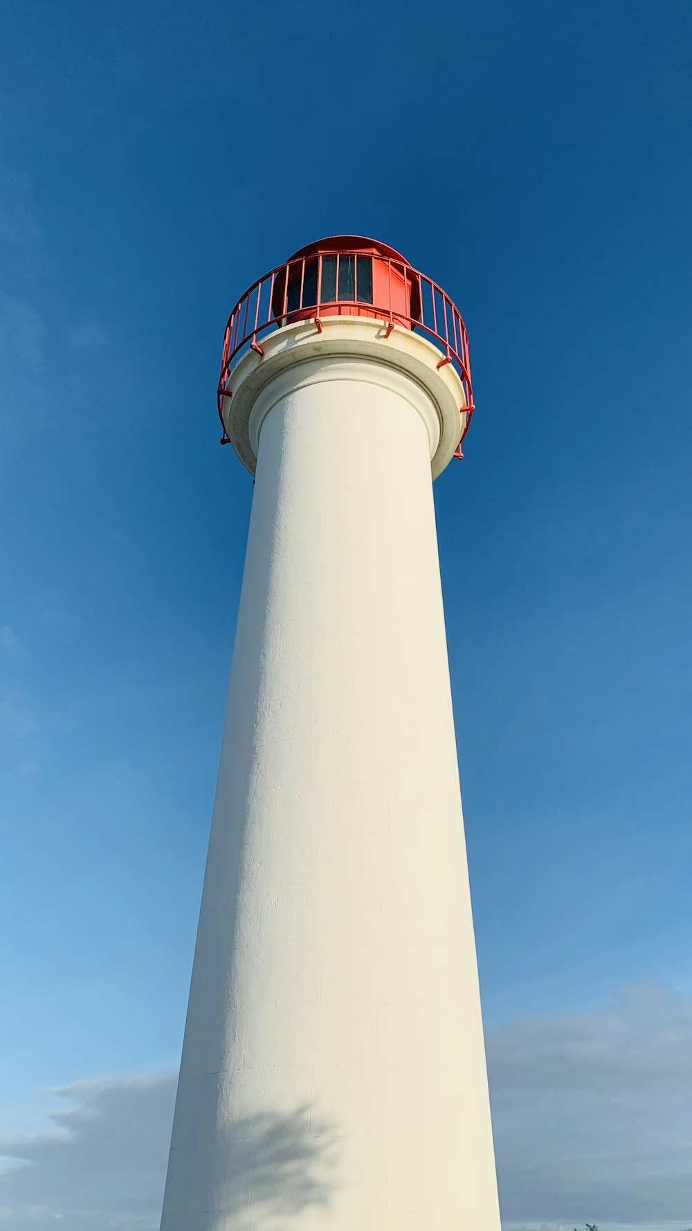 white and red concrete tower under blue sky during daytime