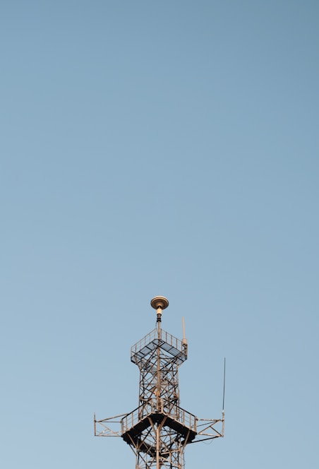 A sleek modern antenna tower against a clear blue sky symbolizing advanced RF technology.