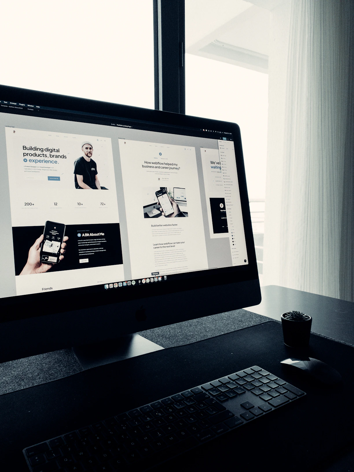 Creative workspace with computer screens showing web design and development projects.
