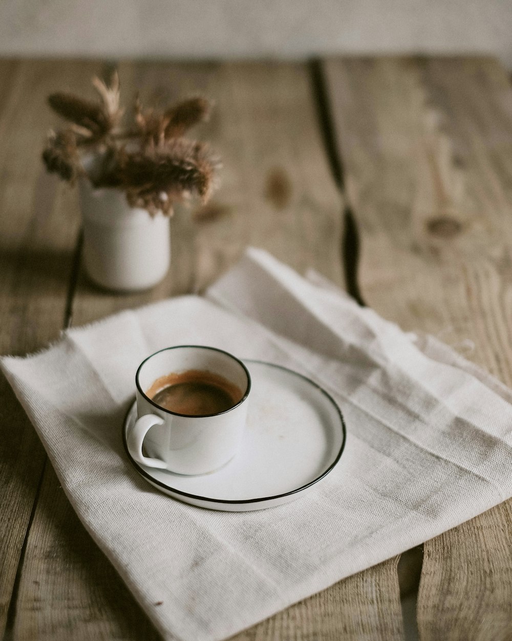 white ceramic cup on white ceramic saucer