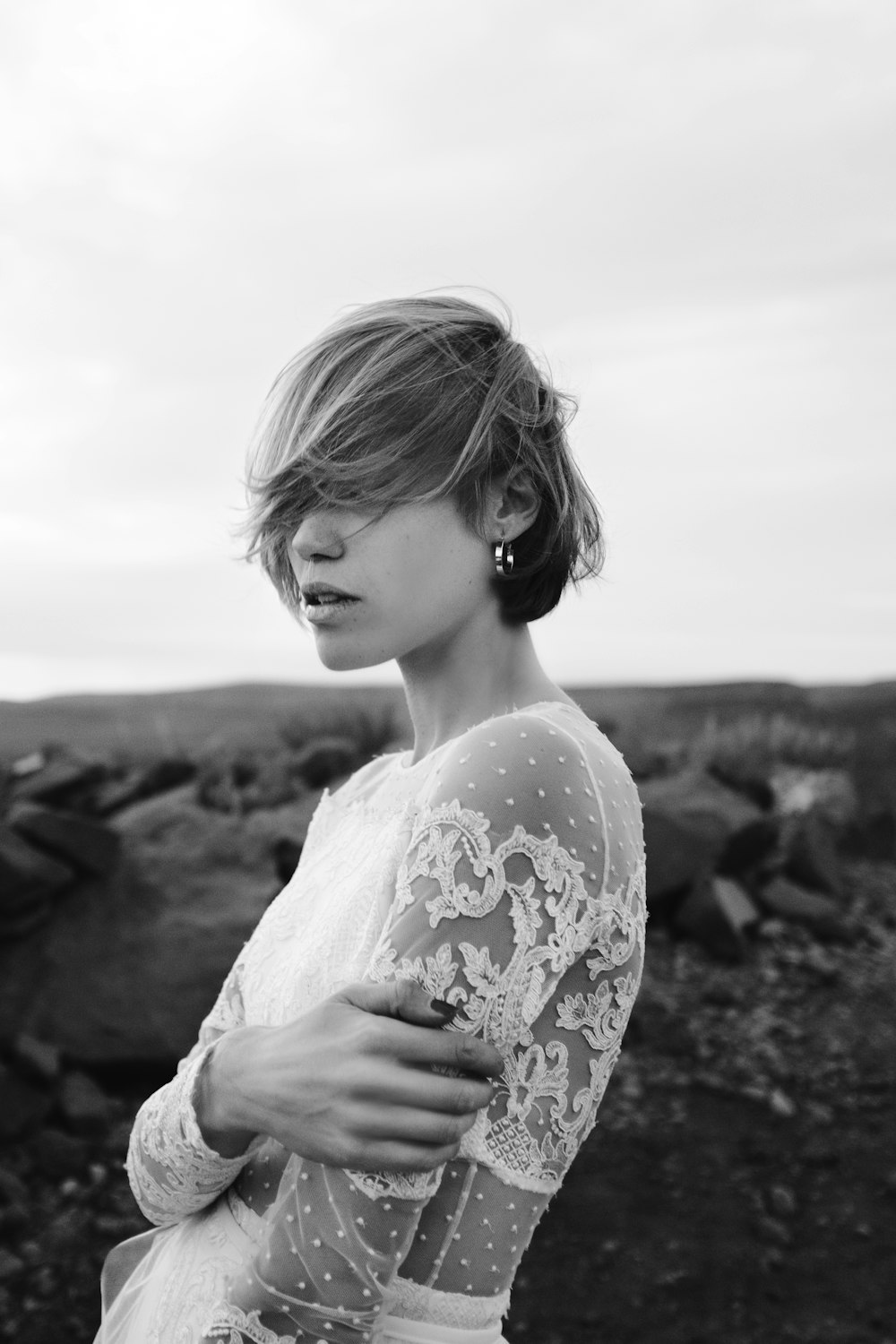 woman in white floral dress standing on rock formation during daytime