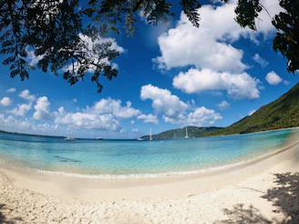 blue sea under blue sky and white clouds during daytime