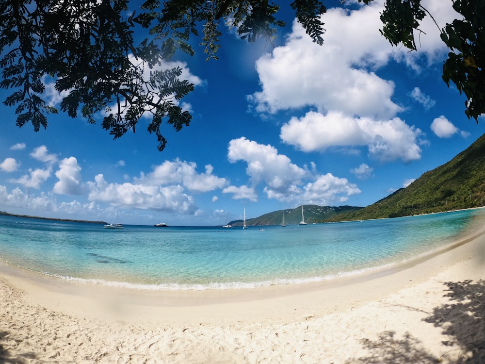 blue sea under blue sky and white clouds during daytime