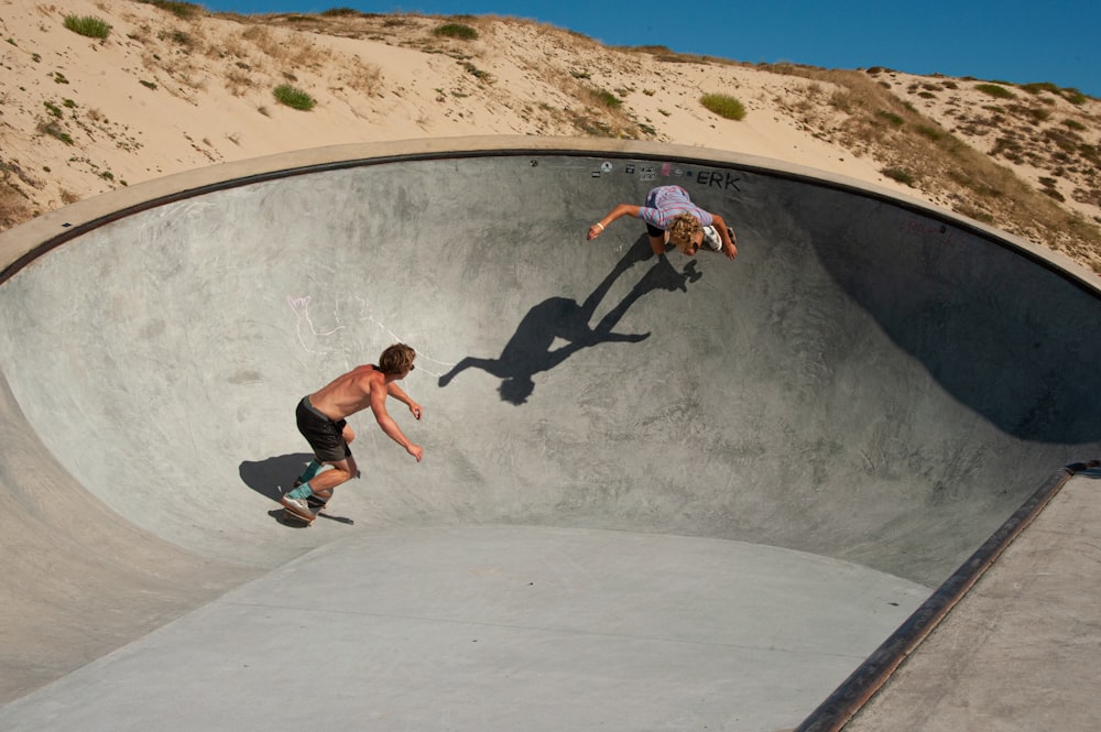 man in black and white shorts riding skateboard during daytime