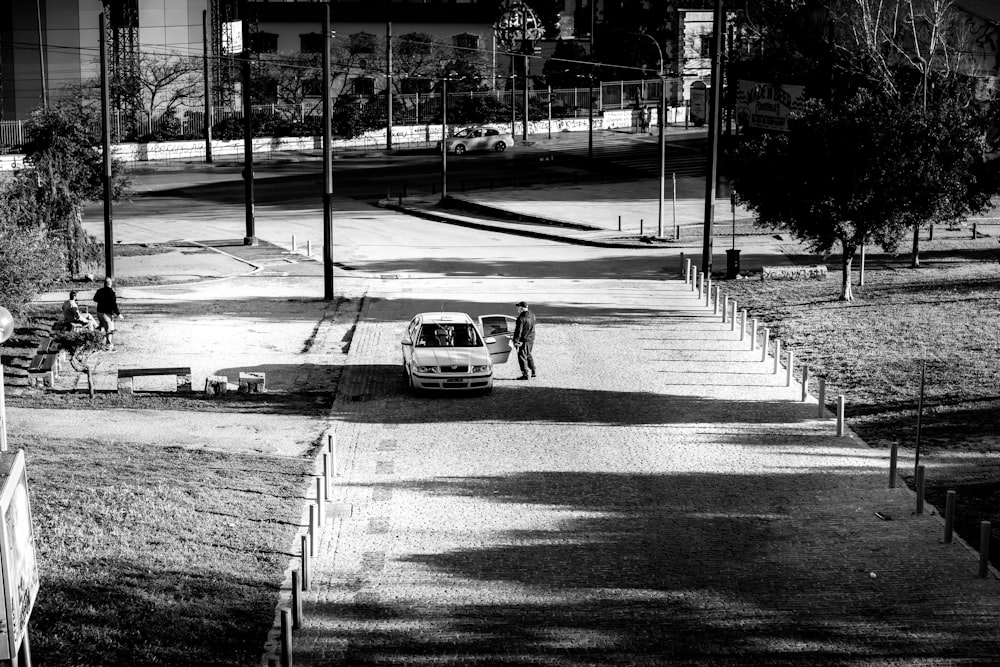 grayscale photo of car on road