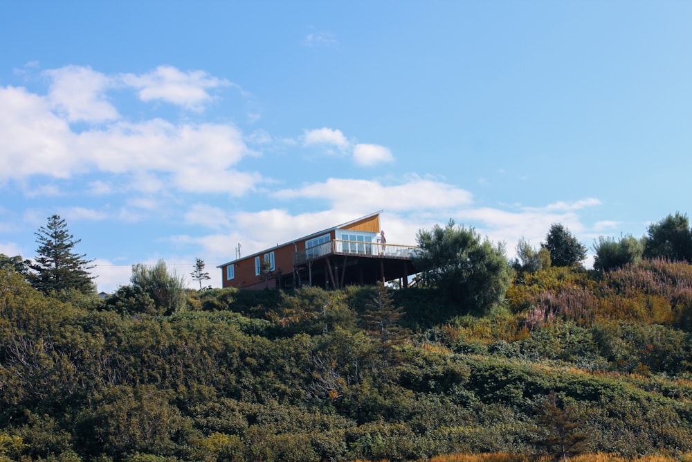 brown and white concrete building near green trees under blue sky during daytime