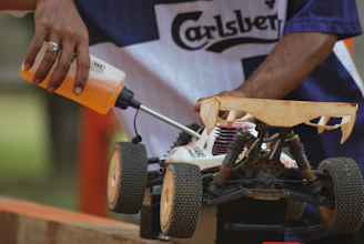 person holding orange and black power tool