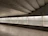 A bright, modern basement with a glossy epoxy floor reflecting soft lighting.