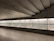 A bright, modern basement with a glossy epoxy floor reflecting soft lighting.