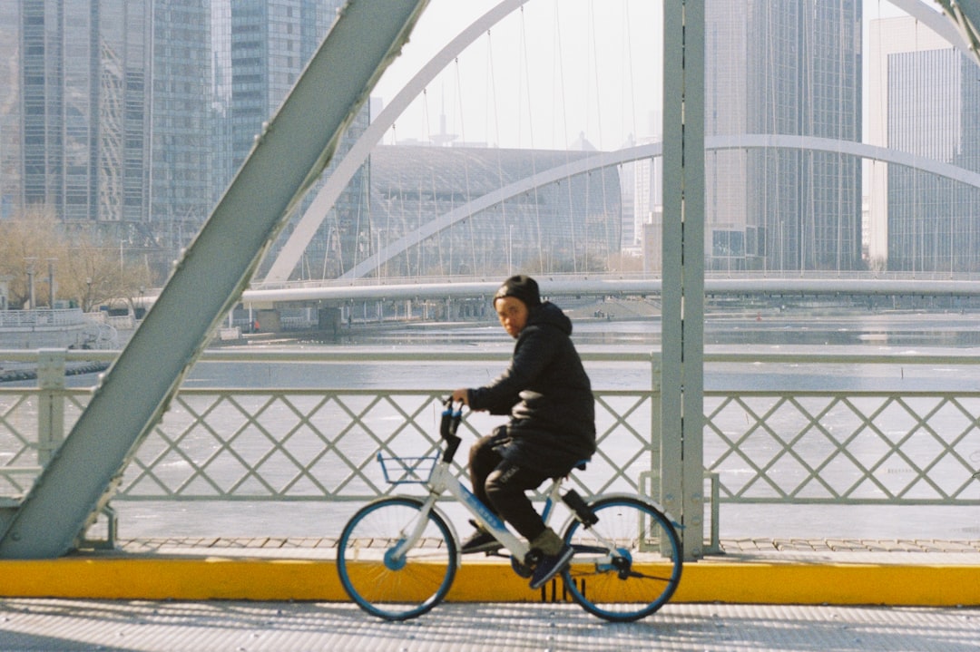 man in black jacket riding on bicycle