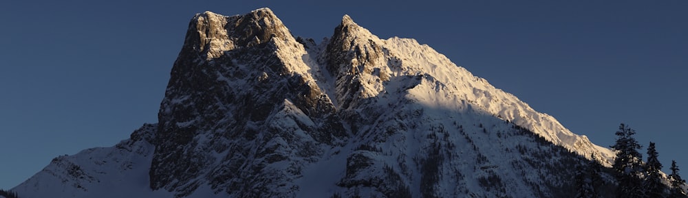 snow covered mountain under blue sky during daytime