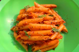 Colorful plate of penne pasta with grilled vegetables and a drizzle of olive oil.