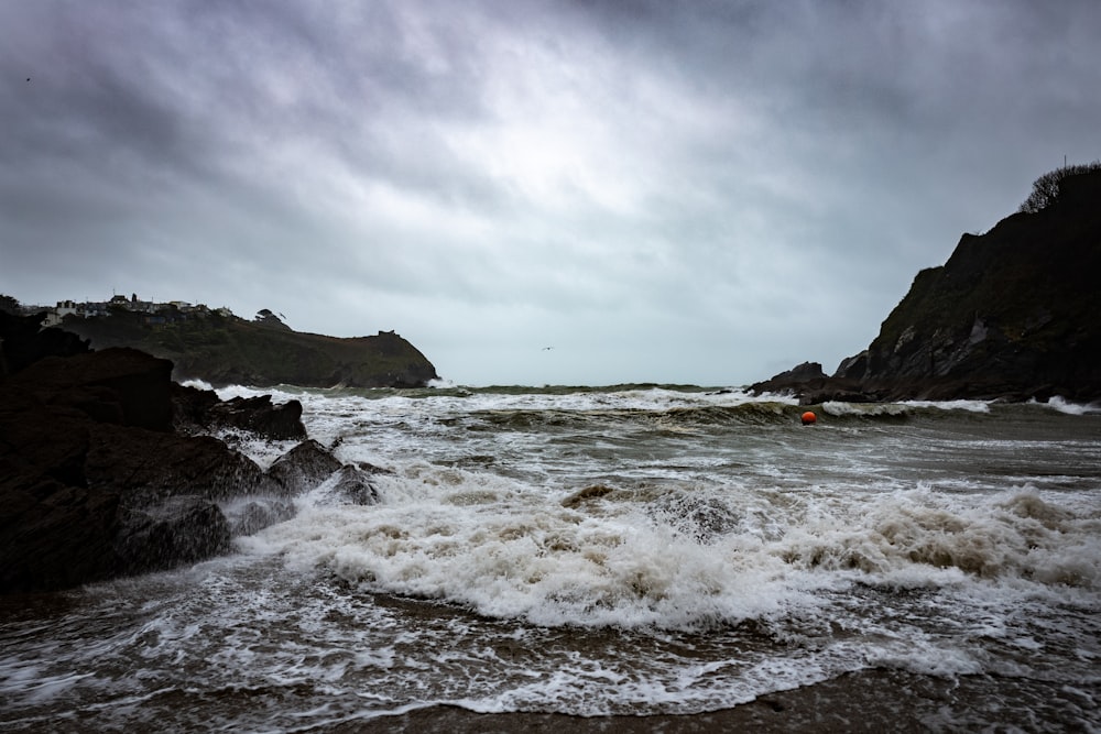 ocean waves crashing on shore during daytime