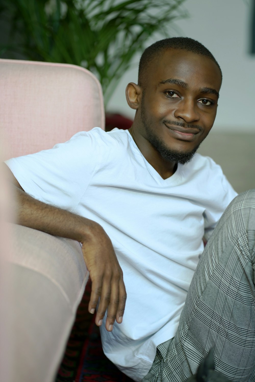 man in white crew neck t-shirt sitting on white sofa