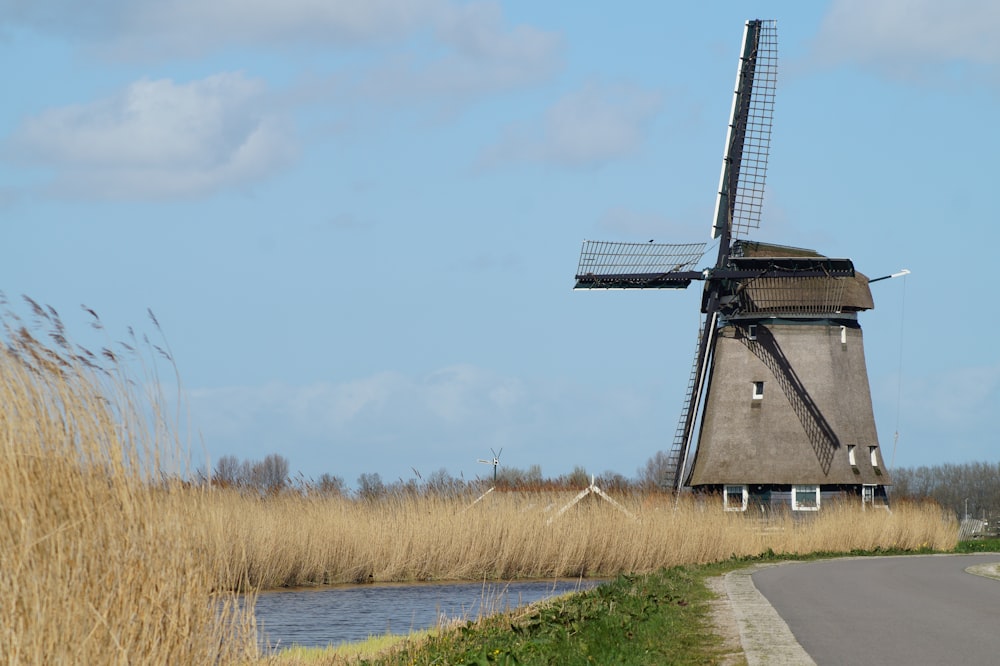 windmill on brown grass field during daytime