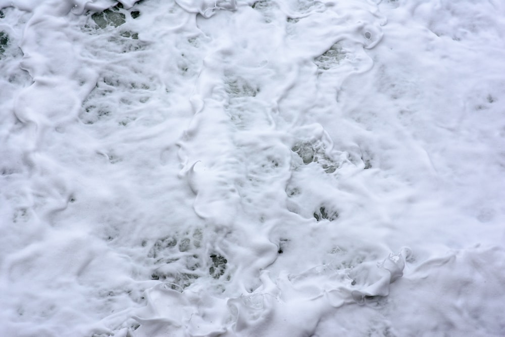 white snow on gray sand