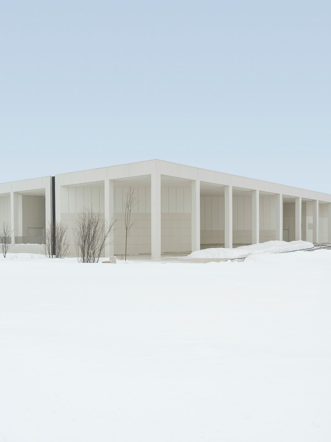 white wooden house on snow covered ground