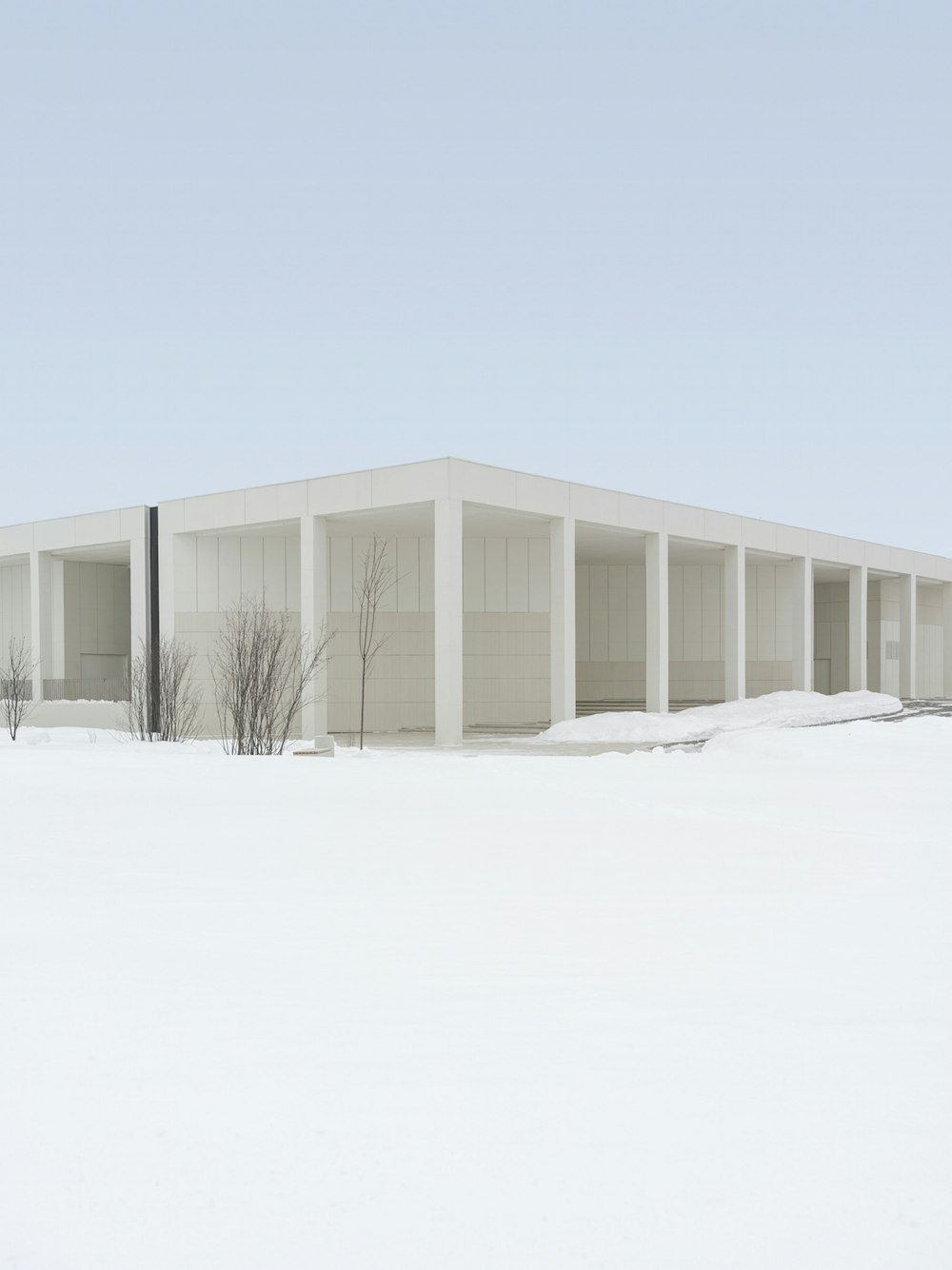 white wooden house on snow covered ground