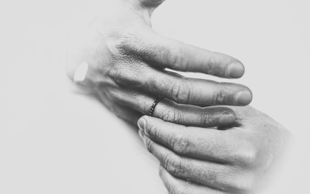 grayscale photo of persons hand