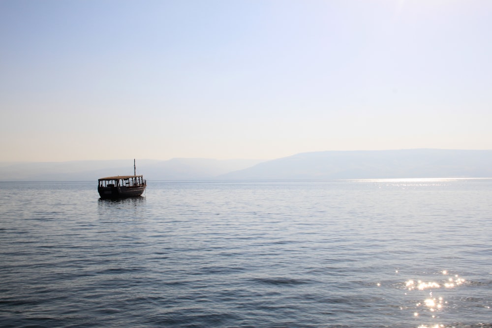 black boat on sea during daytime