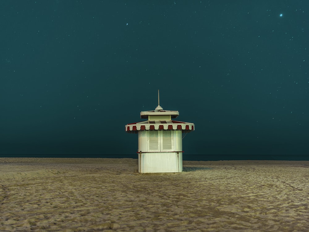 white and brown wooden house on brown sand during night time