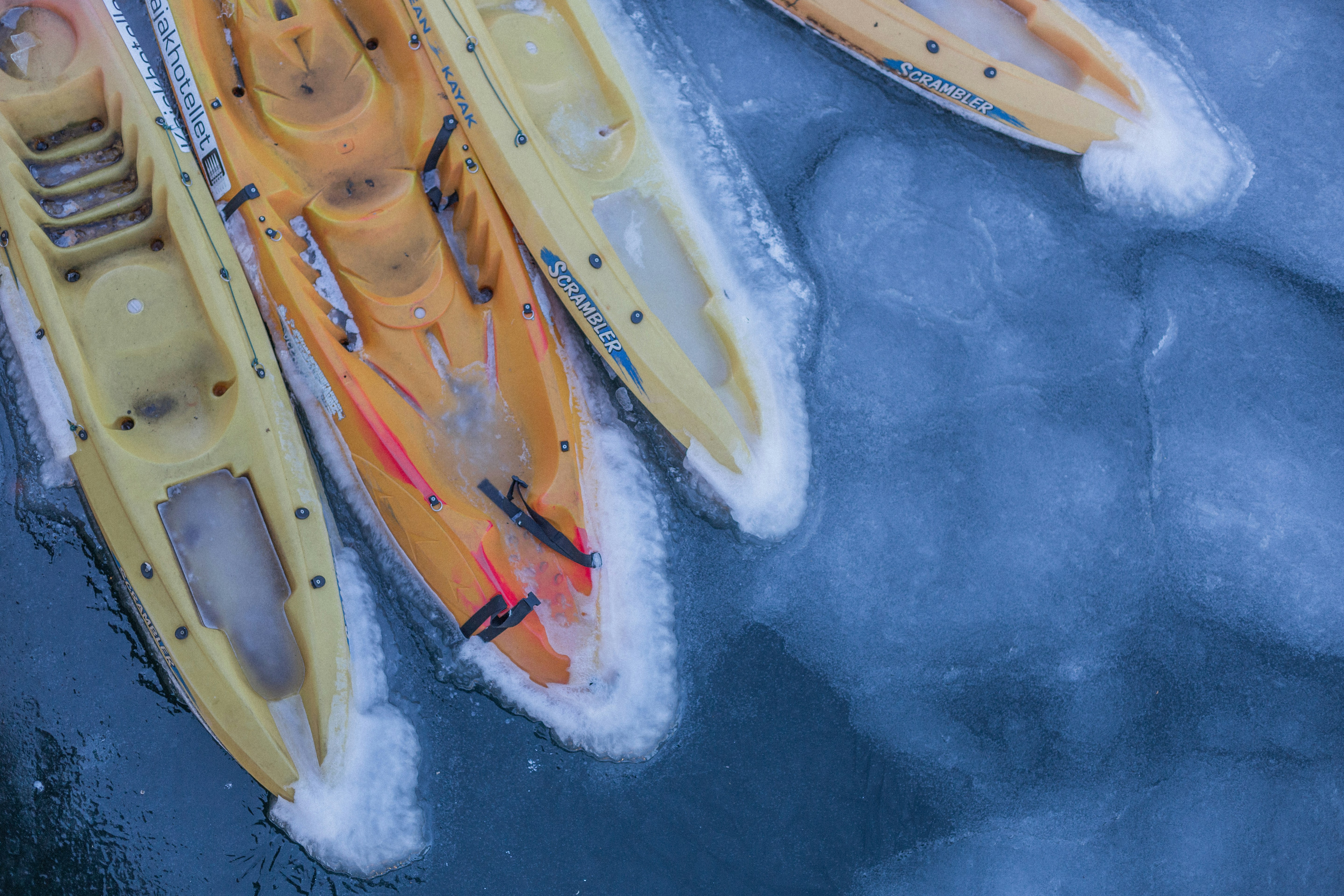 yellow kayak on blue water, Frozen canoes in the canals of Copenhagen
