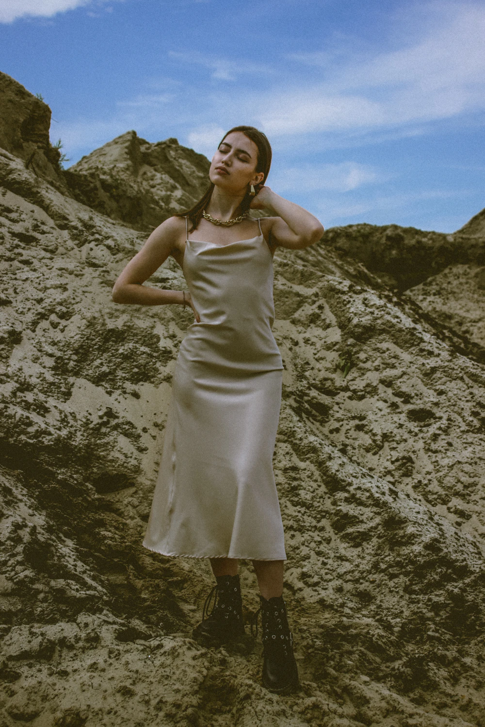 Model wearing a champagne satin slip dress outdoors