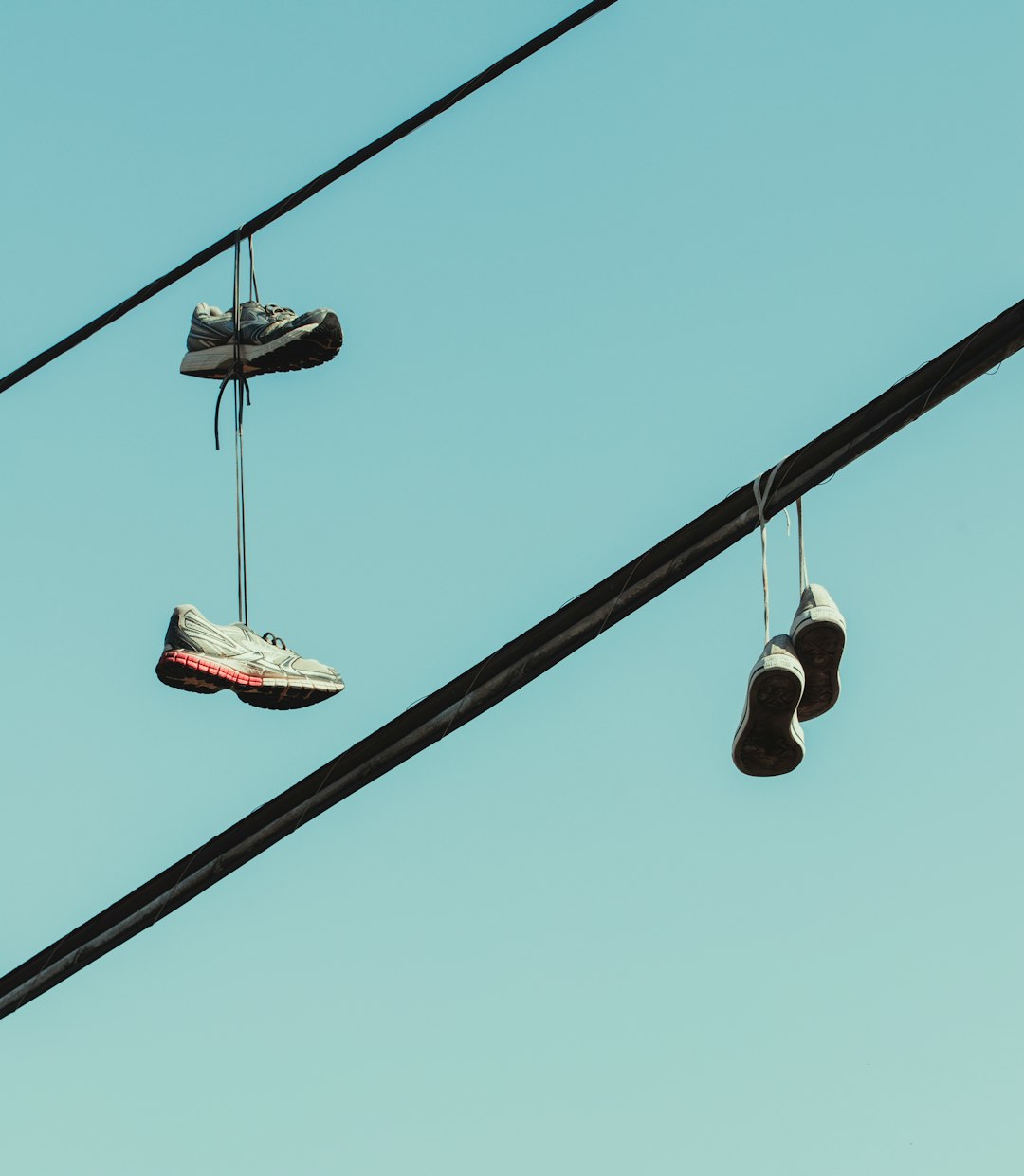 black and white shoes hanging on wire