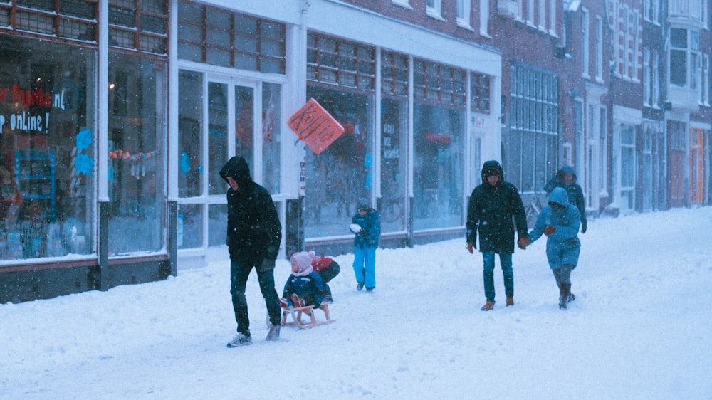 people walking on snow covered ground during daytime