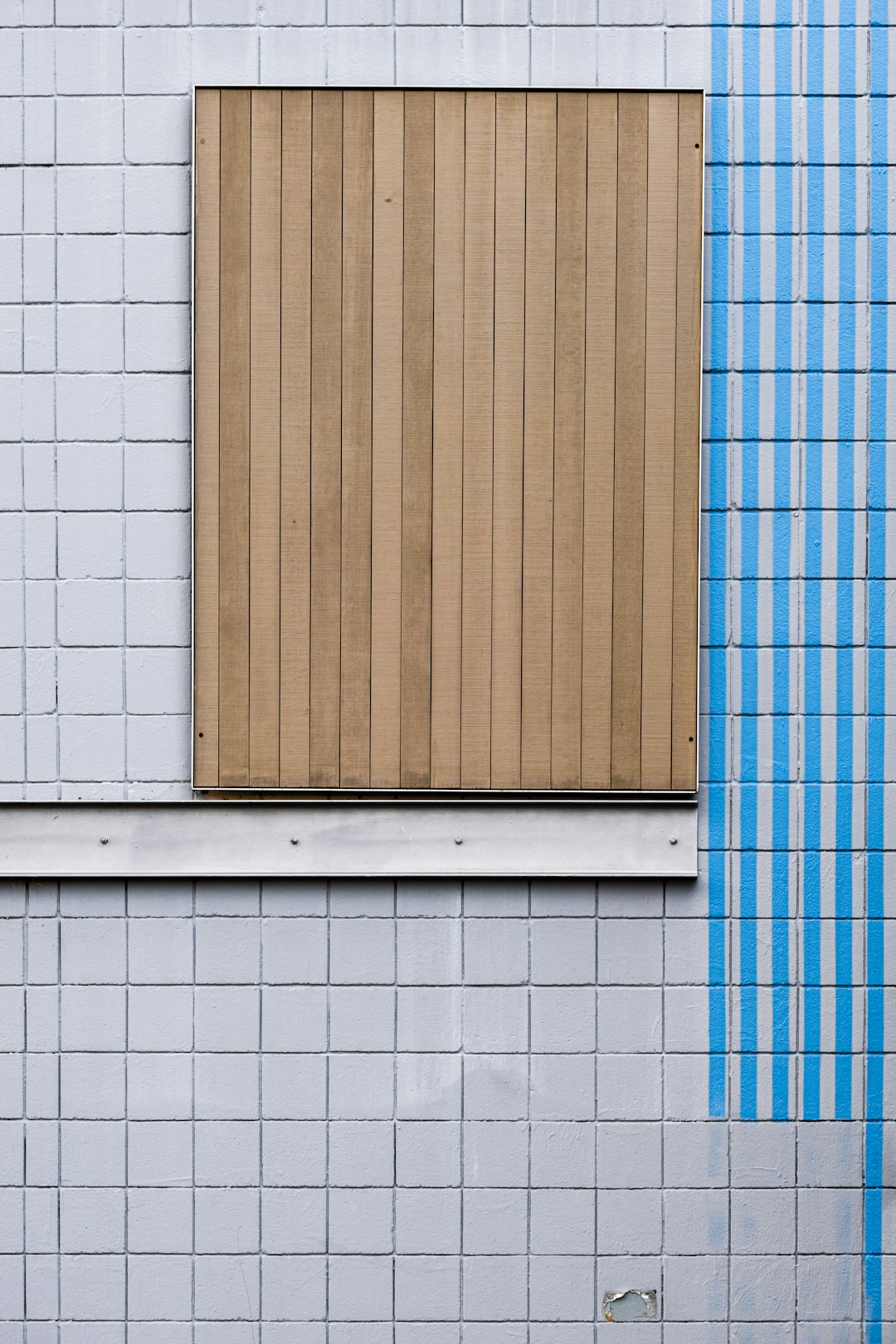 brown wooden door on white concrete wall