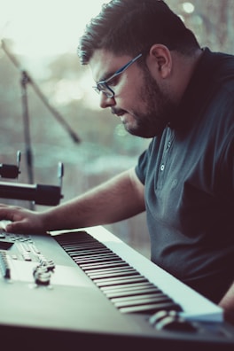 A keyboard player focused on their instrument, surrounded by virtual stage gear.