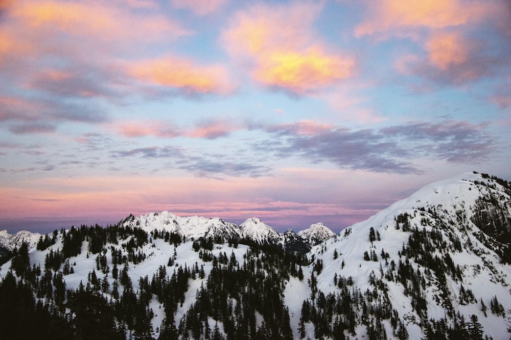 snow covered mountain during sunset