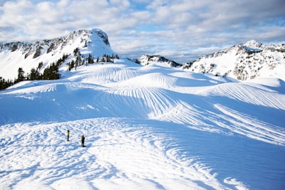 people walking on snow covered mountain during daytime stunning teams background