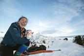 A happy person enjoying a cold drink from an Epicooler at a picnic.
