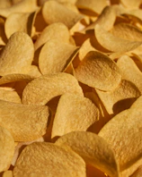 Close-up of a golden, ridged premium crisp catching the light.